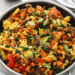 breakfast sausage and sweet potato egg scramble in black pan